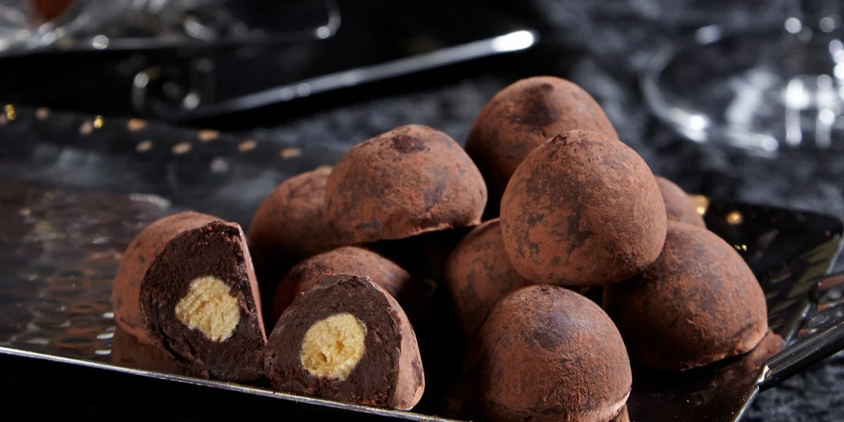 Dark champagne truffles on a silver tray